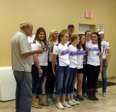 PAXTON MAYOR HAYWARD THOMAS PRESENTED THE DIXIE YOUTH BELLES softball team with a plaque in recognition of the players’ successful run in the league’s World Series in August. The Paxton squad, twice the state championship title holder, finished the national tournament as the runner-up. (Photo courtesy of the city of Paxton)
