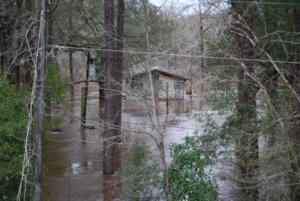 THE OLD HIDE-A-WHILE CAMPGROUND and lodge was inundated by last week's flood. The campground has been closed for some time but this is a good example of the extent of the flooding. As of Tuesday, Jan 5, the river was slowly receding. (Photo by Jeffrey Powell) 