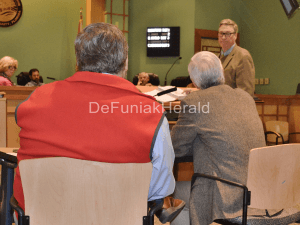 EXPERT WITNESS Charles Gautier (standing) is questioned by attorney Greg Stewart, representing county staff (seated at right), while providing testimony at the Feb. 25 Walton County Zoning Board of Adjustment meeting. An attorney representing SBG-PR, L.L.C, applicants for the Kaiya Planned Unit Development, prevailed in an appeal of the county planning director's interpretation regarding a requirement for a 250-foot buffer in Residential Preservation land use areas within the Neighborhood Planning Area district.(Photo by Dotty Nist)