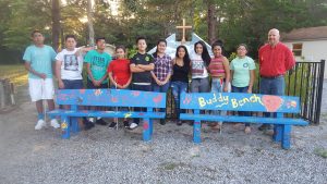 MANUEL PINEDA, LEONARDO ROBLES-MARTINEZ, Luis Ramos, Cinthia Alonso, Antonio Cruz, Donnaluz Bush, Jazmin Paredes-Perez, Larizza Villalobos, Abigail Lara, Jennifer De La Rosa , and George Cowie (l-r) show off their hard work to help other children. The idea behind the benches, explains George Cowie, Confirmation Instructor for St. Margaret of Scotland Catholic Church, is “When a student is feeling lonely, like their best friend is home sick and they're alone on the playground, they can sit on the bench. When others see someone on the bench they know someone is in need of a buddy. Friends also use the benches. It is a way of fostering friendships and combating bullying at a young age.” (Photo by St. Margaret's Religious Education Director, Kathy Russ.)
