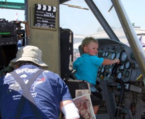 YOUNG AND BULLETPROOF” INDEED. The kids in the crowd at the Marvel of Flight especially loved getting up close to the aircraft on display, including this UH-1 “Huey” helicopter. (Photo by Reid Tucker)
