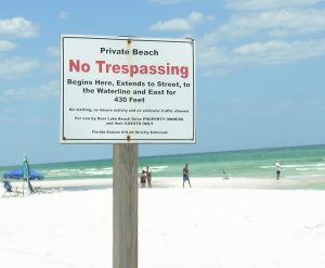 PRIVATE BEACH signs remained on the beach on June 20, six days after the county commission decision to prohibit signs, chains, ropes, fences, and other obstructions on the beach. (Photo by Dotty Nist)
