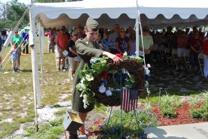 EMERALD COAST YOUNG MARINES Gunnery Sgt. Michaela Cantwell places a wreath at Gulf Cemetery to honor those that have fallen in battle. (Photo by Jeffrey Powell) 