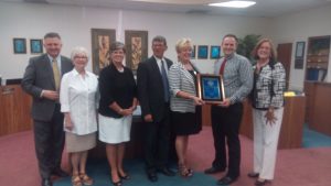 WALTON COUNTY SCHOOL BOARD MEMBERS Mark Davis, Gayle Smith, District Superintendent Carlene Anderson, Board members William Bill Eddins Jr., Florida School Board Association Coordinator of Professional Development Tina Pinkoson, board chair Jason Catalano, and board member Kim Kirby (l-r) celebrate 22 hours of Master Board training completed this year with a plaque presented by Pinkoson.