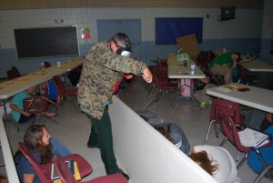 SCHOOL RESOURCE DEPUTY Matt Key simulates an active shooter. This was part of an Aug. 8 school training program exercise called A.L.I.C.E., an acronym for Alert, Lockdown, Initiate, Communicate and Evacuate. (Photo by Jeffrey Powell)