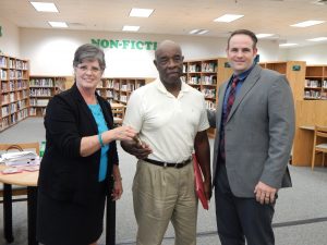 SUPERINTENDENT CARLENE ANDERSON, Tivoli Historical Society President Eddie Williamson, and board chair Jason Catalano (l-r) Williamson with the keys to the old Tivoli school gym, to be used as a community center.