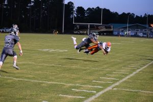 A SOUTH WALTON AND A COTTONDALE player had a mid-air collision during a play in the first half of the Seahawks fifth consecutive win against the Hornets this past Friday night. The Seahawks host Blountstown in their district opener on Friday at 7 p.m. (Photo by Jeffrey Powell)