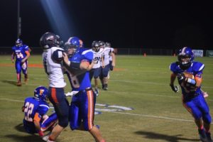 ZACK JOHNSON, Freeport quarterback, helped to clear the way for Weston Bates to make a first down run. Freeport had a good night against Bozeman, winning 42-8. (Photo by Blake McCormick)