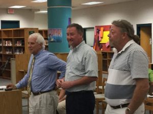 WCSD FACILITIES DIRECTOR MARK GARDNER STANDS WITH LLT Building Corporation Project Superintendent Garry Gould and Project Manager Paul Boyle (l-r) discussing contract issues and completion dates during the Oct. 18 WCSB meeting.