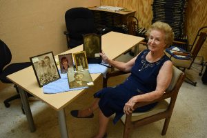 JOYCE ANDERSON sits with the photos she has acquired. The more she looked at the photos the more she wondered if there were any living family members that would like to have their family heirlooms returned to them.“I would really like to re-connect these photos with their family members.” Anderson said. 