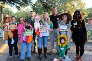 DBPA Halloween Happening Winners (ages 0-2) (l-r) front, Samantha Odom-Honorable Mention, Brandy Odom, Debra Curry, Journey Clark-3rd Place, Addison Black-2nd Place, Vanessa Black, Jaqulin Anderson and mom-1st Place, Takilia Washington (Wal Mart) and L to R, back, Dusty Beck (City) Captain Mike Lolley (City Police). Photo by Cathy Mosley