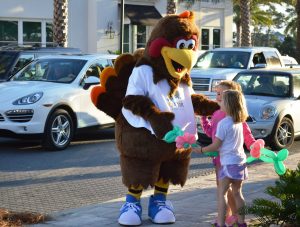 LUCKY, the 30A 10K turkey mascot, delighted children and made for great "selfies" at the Fall Festival held on Nov. 23 at 30Avenue retail center.  (Photo by Dotty Nist)   
